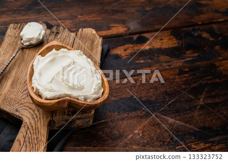 Traditional Mascarpone cheese in wooden bowl. wooden background. top view 133323752