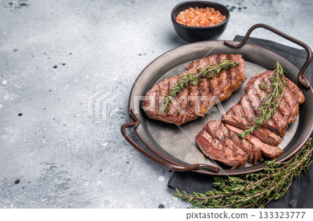 Roast Top blade steak, grilled beef shoulder meat. grey background. top view 133323777