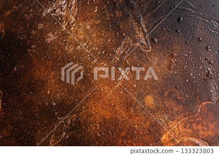 Warm rusty metal background with rich brown tones and rough texture ideal for dark food photography and moody compositions. 133323803