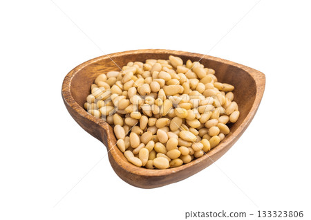A wooden bowl filled with pale pine nuts placed on a clean white background creating a simple natural and minimal food scene perfect for stock use 133323806