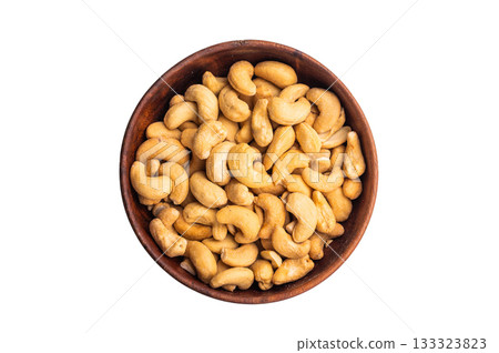 Cashew nuts in a wooden bowl on a clean white background creating a bright minimal ingredient 133323823