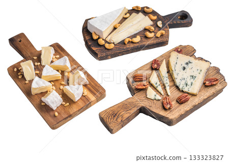 Selection of creamy Camembert soft Brie and bold Roquefort arranged with cashews pine nuts and pecans over wooden boards. Selection of creamy Camembert soft Brie and bold Roquefort arranged with cashews pine nuts and pecans over wooden boards. 133323827