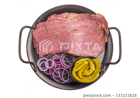 hinly sliced pastrami on a plate with red onion rings and pickled cucumbers. Smoked deli beef with marbled texture on a clean white background, ready to serve.. hinly sliced pastrami on a plate with red onion rings and pickled cucumbers. Smoked deli beef with marbled texture on a clean white background, ready to serve.. 133323828