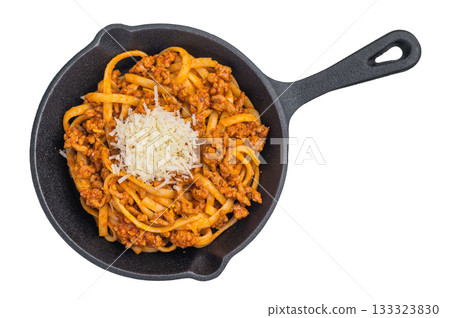 Delicious pasta bolognese with savory meat ragu and parmesan shreds presented in a cast iron skillet on minimalist white background. Delicious pasta bolognese with savory meat ragu and parmesan shreds presented in a cast iron skillet on minimalist white background. 133323830