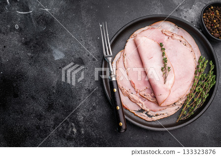Spalla slices arranged with herbs and a vintage fork on a dark stone surface highlighting texture and artisanal food styling. Spalla slices arranged with herbs and a vintage fork on a dark stone surface highlighting texture and artisanal food styling. 133323876