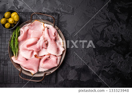 Pork Ham, Sliced Prosciutto Cotto on steel tray. black background. top view Pork Ham, Sliced Prosciutto Cotto on steel tray. black background. top view 133323948