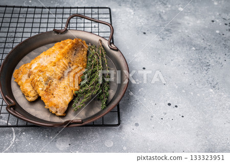 Fried pollock white fish fillet. grey background. top view Fried pollock white fish fillet. grey background. top view 133323951