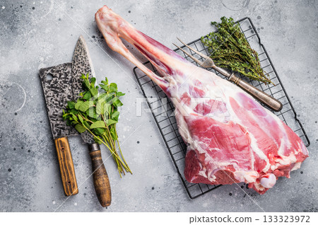 Raw whole lamb leg, fresh mutton meat. grey background. top view Raw whole lamb leg, fresh mutton meat. grey background. top view 133323972