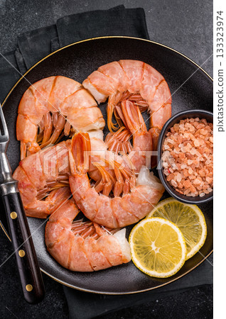 Uncooked Headless Red shrimps, raw Prawns on plate. black background. top view Uncooked Headless Red shrimps, raw Prawns on plate. black background. top view 133323974