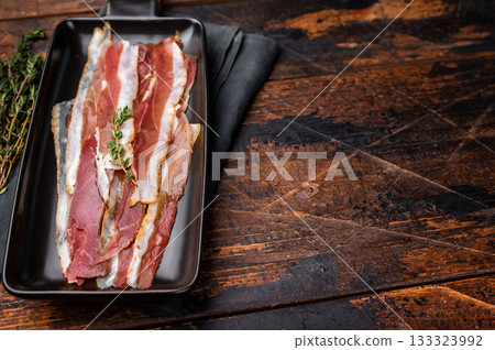 Smoked duck pastrami meat slices. wooden background. top view Smoked duck pastrami meat slices. wooden background. top view 133323992
