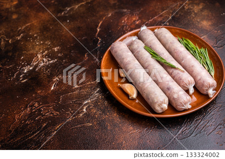 Raw Sausages with forcemeat mincemeat with herbs in plate. brown background. top view Raw Sausages with forcemeat mincemeat with herbs in plate. brown background. top view 133324002