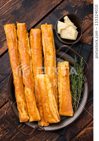 Homemade pastry, Bread sticks with cheese and salt. wooden background. top view Homemade pastry, Bread sticks with cheese and salt. wooden background. top view 133324010