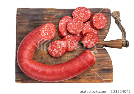 Whole and sliced Turkish sucuk (sujuk) on a rustic cutting board. Traditional spicy dry-cured sausage. 133324041