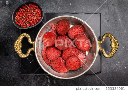 Fried Turkish sucuk (sujuk) in a copper pan on a dark stone background with copy space. Traditional breakfast. 133324061