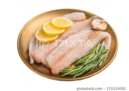 Pollock sea fish fillets, raw whitefish on a plate with herbs and lemon isolated on white background. top view Pollock sea fish fillets, raw whitefish on a plate with herbs and lemon isolated on white background. top view 133324092
