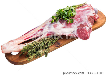 Whole raw goat leg, uncooked meat on butcher board isolated on white background. top view Whole raw goat leg, uncooked meat on butcher board isolated on white background. top view 133324103