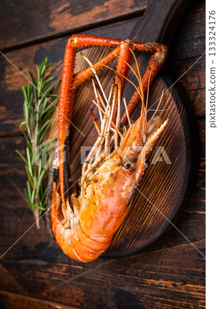Juicy grilled giant river prawn shrimp served with rosemary, a mouthwatering dish for your next barbecue. wooden background. top view Juicy grilled giant river prawn shrimp served with rosemary, a mouthwatering dish for your next barbecue. wooden background. top view 133324176