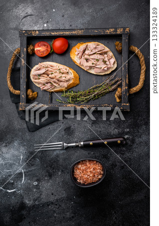 Gourmet style tuna sandwich with fresh herbs and spices, elevating your lunchtime experience to the next level. black background. top view Gourmet style tuna sandwich with fresh herbs and spices, elevating your lunchtime experience to the next level. black background. top view 133324189