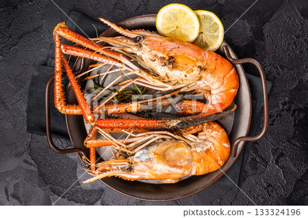 Succulent grilled rosenbergii prawn shrimp, perfectly charred and bursting with flavor, ideal for seafood lovers. black background. top view Succulent grilled rosenbergii prawn shrimp, perfectly charred and bursting with flavor, ideal for seafood lovers. black background. top view 133324196