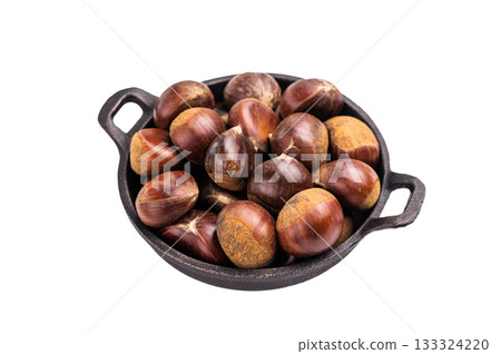 Raw chestnuts in rustic skillet ready for cooking isolated on white background Raw chestnuts in rustic skillet ready for cooking isolated on white background 133324220