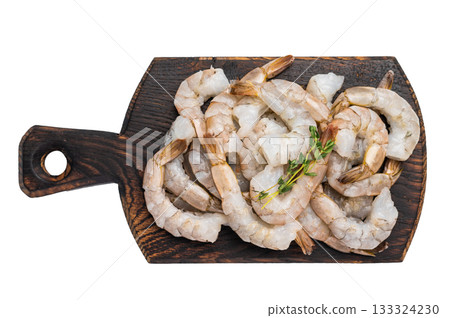 Raw shrimps, headless fresh prawns on a wooden board isolated on white background. 133324230