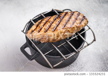 Delicious kofta kebabs sizzling on the grill, infused with aromatic spices for a mouthwatering culinary experience.. white background. top view Delicious kofta kebabs sizzling on the grill, infused with aromatic spices for a mouthwatering culinary experience.. white background. top view 133324231