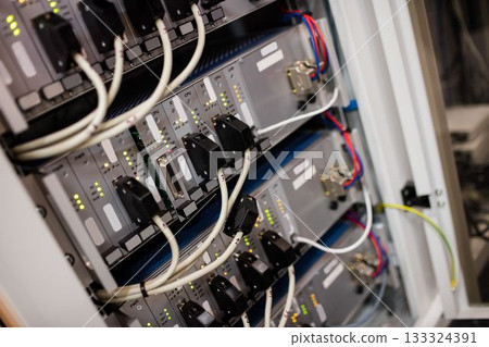 Showing flat design cabinet featuring mounted modules looping data cables LED lights cable clips 133324391