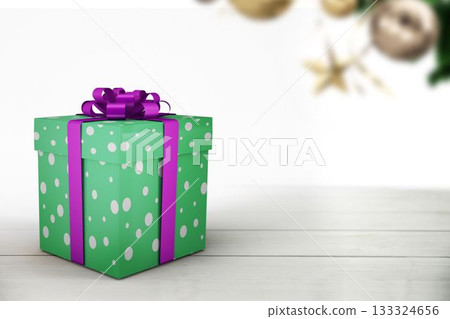 Green polka-dot gift box is sitting on tabletop in flat design, gold baubles and star ornament 133324656