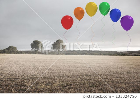 Seven colored balloons are hovering above harvested field under grey sky in flat design style 133324750