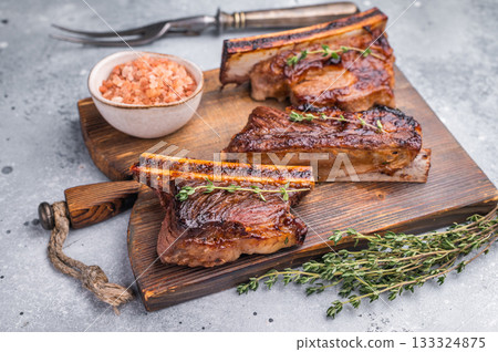 Premium grilled short ribs with thyme and pink salt. Ample gray copy space for text or design. 133324875