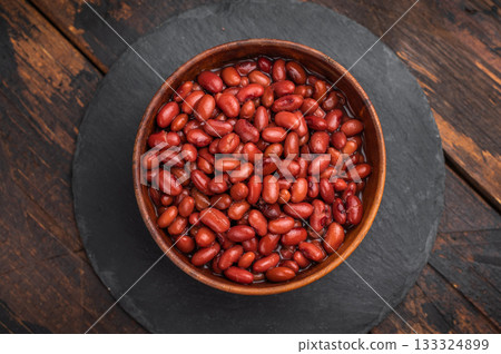 Simple, wholesome portion of kidney beans in a rustic wooden dish. Ideal for diet, vegetable, and vegan recipe blogs. 133324899