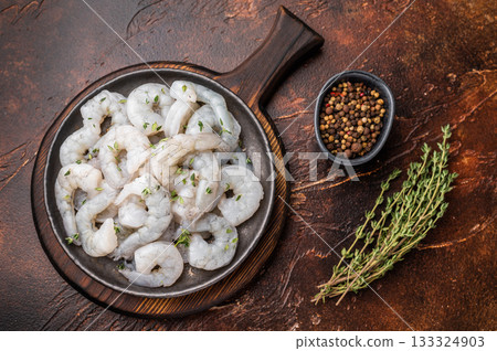 Fresh seafood prawn shrimp and gourmet ingredients ready for cooking. Top view on a wooden cutting board with spices. Fresh seafood prawn shrimp and gourmet ingredients ready for cooking. Top view on a wooden cutting board with spices. 133324903