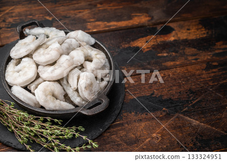Heap of icy frozen seafood (shrimp prawns) on a wooden table, perfect for dinner, lunch, or appetizer recipes. Heap of icy frozen seafood (shrimp prawns) on a wooden table, perfect for dinner, lunch, or appetizer recipes. 133324951