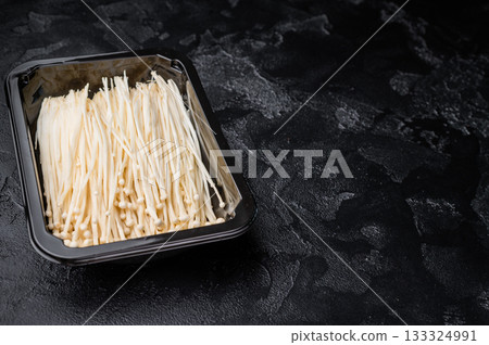 Top view of raw Enokitake (Golden Needle) mushrooms. Healthy Asian food ingredient. Perfect for food blogs and gourmet cooking concepts. Top view of raw Enokitake (Golden Needle) mushrooms. Healthy Asian food ingredient. Perfect for food blogs and gourmet cooking concepts. 133324991