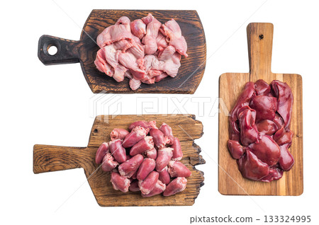 Raw poultry organs chicken hearts, liver, and gizzards on rustic wood boards, high protein ingredients for traditional cooking. Raw poultry organs chicken hearts, liver, and gizzards on rustic wood boards, high protein ingredients for traditional cooking. 133324995