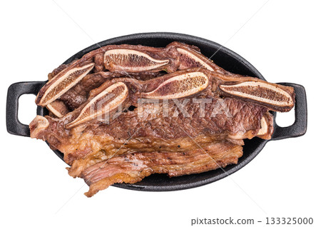 Grilled beef short ribs (Flanken cut) served hot in a cast iron skillet. Isolated on a clean white background. 133325000