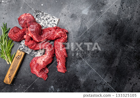Alternative Beef cut Machete Skirt Steak, raw prime meat on butcher table. black background. top view Alternative Beef cut Machete Skirt Steak, raw prime meat on butcher table. black background. top view 133325105
