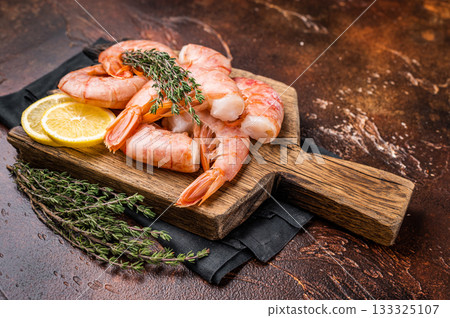 Fresh raw Headless Red Argentine shrimps, Prawns on wooden board. brown background. top view 133325107