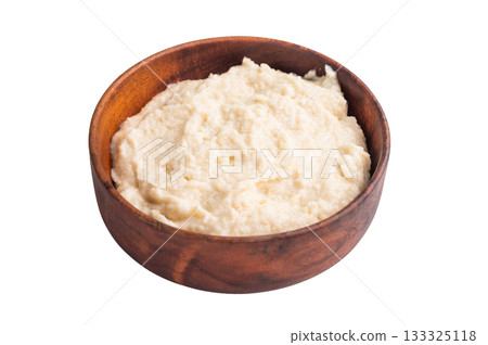Creamy homemade horseradish sauce served in a rustic wooden bowl on a clean white background. Classic studio top view. Creamy homemade horseradish sauce served in a rustic wooden bowl on a clean white background. Classic studio top view. 133325118