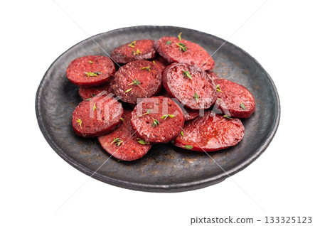 Pan-fried Turkish sucuk (sujuk) slices garnished with thyme on a dark plate. Spicy sausage breakfast or appetizer. 133325123