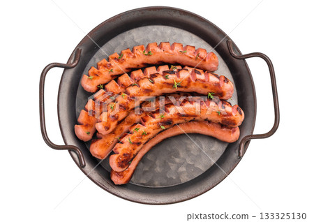 Top view of six cooked sausages with grill marks, served on a rustic metal platter. Perfect for menu design or food advertisement 133325130