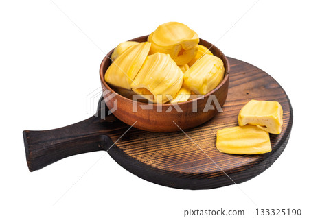 Sweet, golden jackfruit pods (bulbs) served in a rustic wooden bowl on a dark cutting board. Fresh, tropical fruit dessert or snack. 133325190