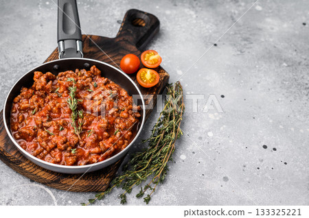 Italian bolognese sauce with ground beef in a pan. grey background. top view Italian bolognese sauce with ground beef in a pan. grey background. top view 133325221