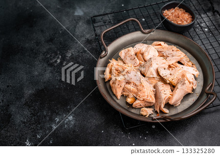 Roast salmon fillet, pulled fish meat on a steel tray. black background. Top view 133325280