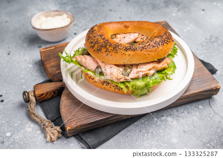 Branch with Bagel sandwich , lox, smoked salmon, lettuce and cream cheese on a plate. gray background. top view 133325287