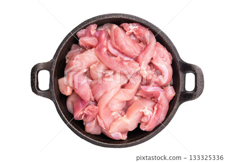 Raw Chicken sliced thighs fillets in a skillet isolated on white background Raw Chicken sliced thighs fillets in a skillet isolated on white background 133325336