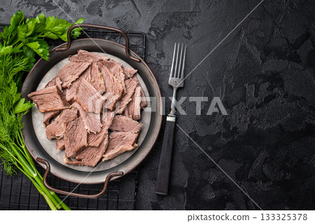 Boiled sliced beef meat in a steel tray. black background. top view Boiled sliced beef meat in a steel tray. black background. top view 133325378