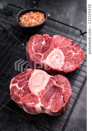 Fresh raw ossobuco Premium veal shank, ideal for slow cooking and creating hearty, comforting meals that impress. black background. top view Fresh raw ossobuco Premium veal shank, ideal for slow cooking and creating hearty, comforting meals that impress. black background. top view 133325438