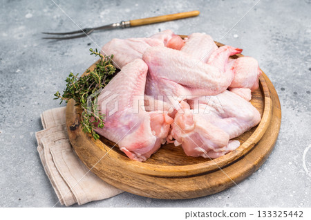 Fresh raw chicken wings, perfect for marinating and grilling, ready to become the star of your next barbecue. grey background. top view 133325442