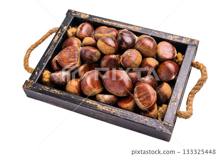 Fresh raw chestnuts in a wooden tray isolated on white background 133325448